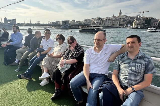 People similing on deck of a boat